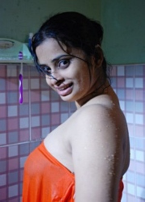 Smily indian stunner in sexy red dress seductively posing in the restroom. - Picture 3