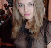 Brunette teen girl in black seethrough outfit teasingly undressing and