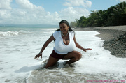 Xxx pics of amateur ebony babe willingly exposes her enormous boobs on the beach.