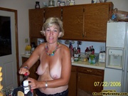 Mature blonde housewife in red peignoir posing on a cam before going wild with her younger lover.