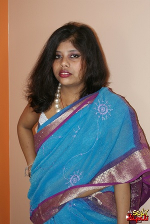 Cool pics with a real Indian girl in a blue sari undresses to expose her chubby delights on cam - Picture 2