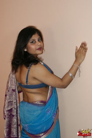 Cool pics with a real Indian girl in a blue sari undresses to expose her chubby delights on cam - XXXonXXX - Pic 3