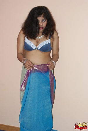 Cool pics with a real Indian girl in a blue sari undresses to expose her chubby delights on cam - Picture 4