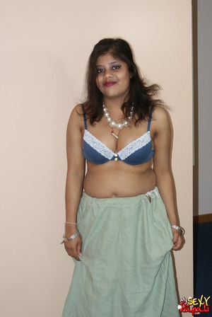 Cool pics with a real Indian girl in a blue sari undresses to expose her chubby delights on cam - Picture 5