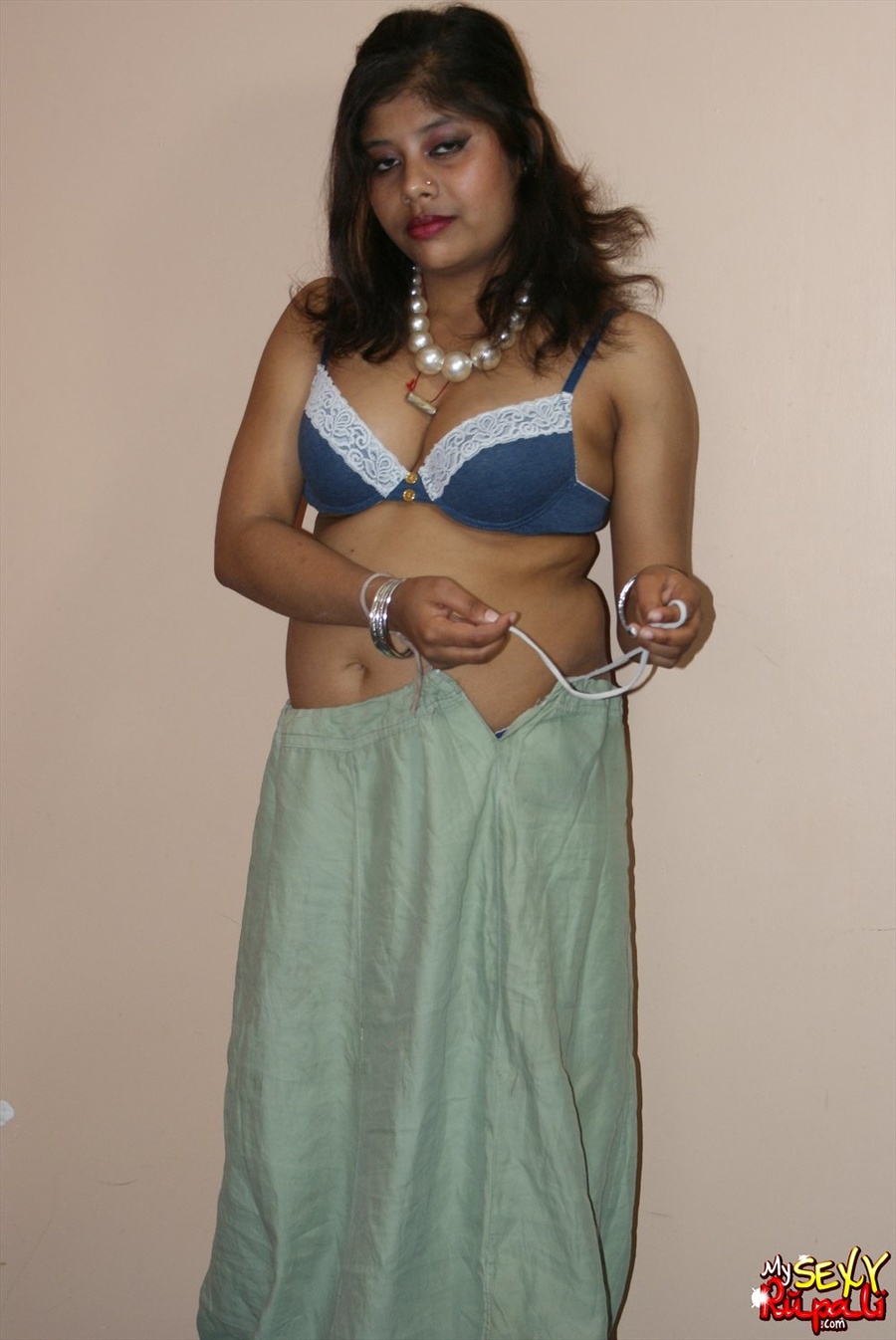 Cool pics with a real Indian girl in a blue sari undresses to expose her chubby delights on cam - XXXonXXX - Pic 6
