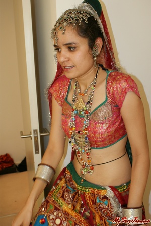 Sexy Indian girl in national costume and jewelry takes off her clothes and stays naked in her ornaments - Picture 1