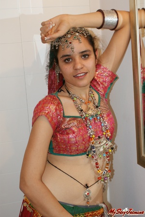 Sexy Indian girl in national costume and jewelry takes off her clothes and stays naked in her ornaments - Picture 2