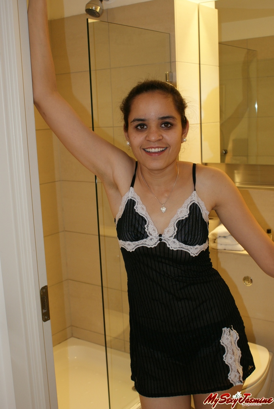 Dirty Indian chick in black night gown undresses to demonstrate her small  tits. Picture 1.