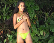 Long-haired tropical beauty dancing very hot dance in bikini at the jungle