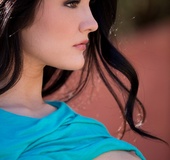 Brunette girl in jeans and a blue jumper gets naked outdoors to demonstrate