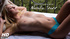Horny blonde gal in blue jeans and blouse to relax on the bed and satisfy