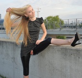 Nasty blonde chick in latex pants with a hole on her pussy shows it off