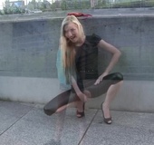 Blonde girl gets naughty and shows off her bald pussy through the hole