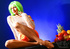 Dirty milf in a green wig and orange combo posing in transparent tights