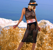 Lovely blonde mom in a crochet dress and a hat spreads her legs in stocking