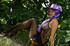 Splendid mom in a crochet dress, a purple hat and a scarf exposes her