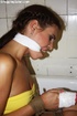 Hot red chick in a yellow dress with a gag in her mouth hogtied in the