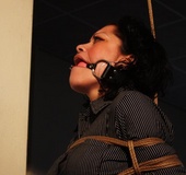 Brunette gagballed chick in clothes pendulating on a rope tightly bound