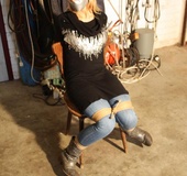 Blonde girl in jeans gets tightly roped to the chair with her mouth gagtaped