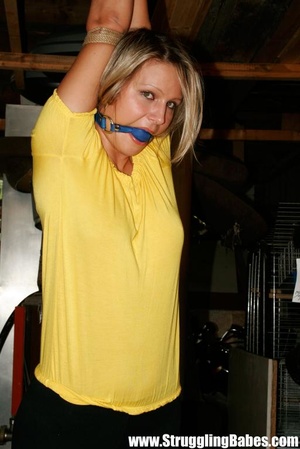 Blonde gal in a yellow T-shirt dangling  - Picture 2