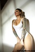 Good-looking tattooed pornstar in a white vest posing for the explicit