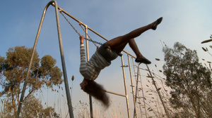 Long-haired blonde chick in a striped blouse swinging on the swings and then fingering her cooch in the field - Picture 2