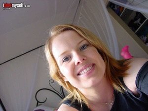 Pretty ginger teen enjoys demonstrating her pierced clit and big melons on cam - Picture 1