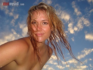 Very hot blonde chick in an orange bikini taking it off to present her awesome tits in the sunset sea - XXXonXXX - Pic 5