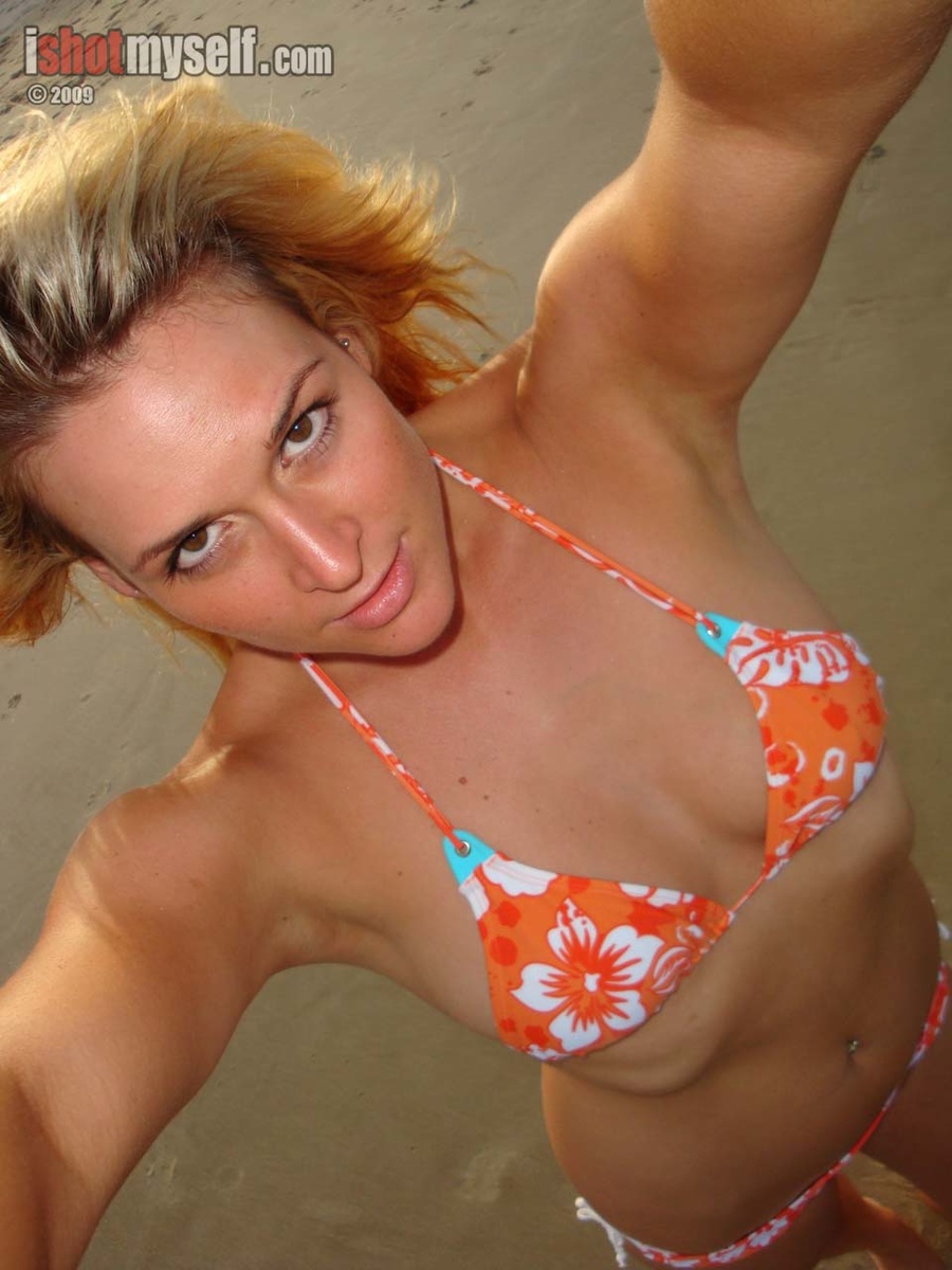 Very hot blonde chick in an orange bikini taking it off to present her awesome tits in the sunset sea - XXXonXXX - Pic 16