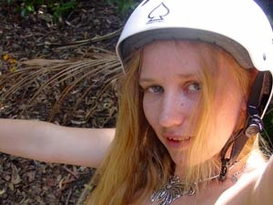 Red teen bitch in a white helmet shooting herself on the bike - Picture 1