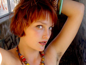 Red chick in beads shooting herself with her shaggy underarms - Picture 2