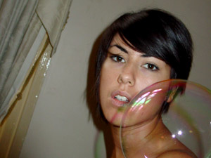 Hot teen brunette taking her own picture with lots of soap bubbles - Picture 1