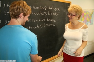 Lustful mature teacher in glasses and a  - Picture 1