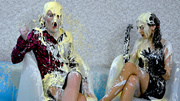 Two fully dresses babes get poured with paint when sitting and talking