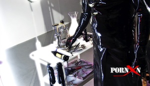 Blonde bound girl gets pissed by master and mistress in latex suits - Picture 1