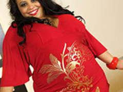 Plump ebony mom in red dress gives titjob - Picture 1