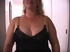 Fat blonde mom in black dress and golden high heels