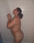 Chubby ponytailed housewife taking shower