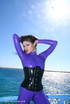 Flexible brunette in lilac latex and stilettos gets topless