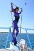 Flexible brunette in lilac latex and stilettos gets topless