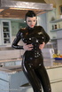Tall blond babe in black latex and boot posing on the kitchen counter