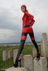 Slim and tall babe posing in red and black latex