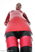 Slim and tall babe posing in red and black latex