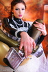 Flexible brunette latex babe shows her adorable tits