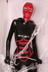 Sexy brunette in black latex jumpsuit takes on red mask