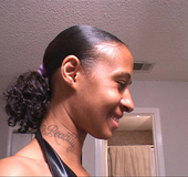 Hot ebony in black boots posing for the camera and showing her neck tattoo