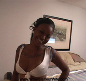 Very hot likable tattooed black chick shows off her seductive boobs and