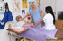 Two sexy voluptuous nurses nursing a stiff hard dick with their tongues