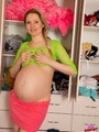 Pregnant girl in top and miniskirt shows - Picture 1
