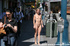 Smiling blonde happy to mingle with public in her nudity